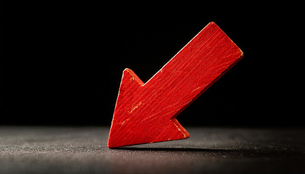 Red wooden arrow pointing down on black background. Business, market decline or economic.