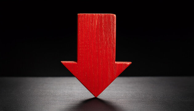 Red wooden arrow pointing down on black background. Business, market decline or economic.