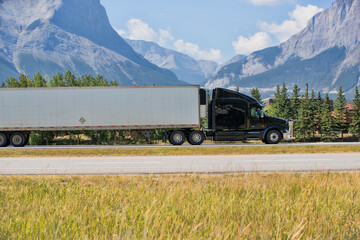 Heavy Cargo on the Road. A truck hauling freight along a highway. Taken in Alberta, Canada