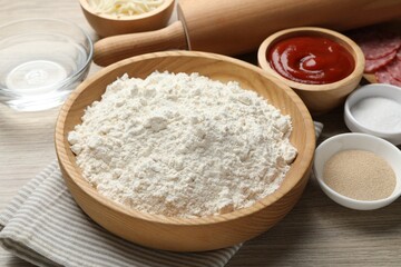 Making calzone pizza. Different ingredients on wooden table, closeup