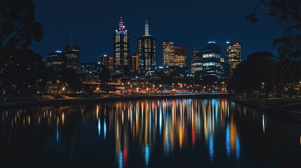 Fototapeta premium A city skyline at night reflected in a dark river.