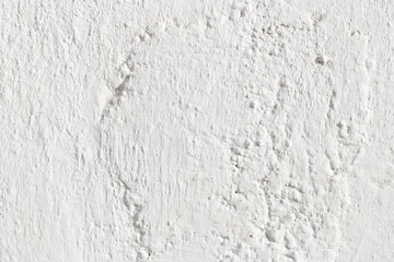 A rough white wall, with cracks caused by time. Texture.