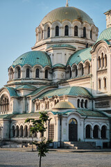 Fit female cyclist wearing cycling kit, glasses and helmet standing with her bicycle during sunset on yacht club background. Healthy lifestyle concept.  Cycling adventure in Spain.