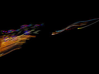 abstract streaming waves of colorful energy and light reaching toward each other isolated on a black background technology theme