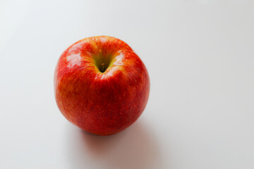 red juicy large apple with details and texture on a white background