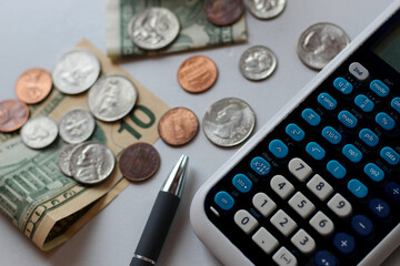 calculator pen and money close-up for spending trends planning and finance market background