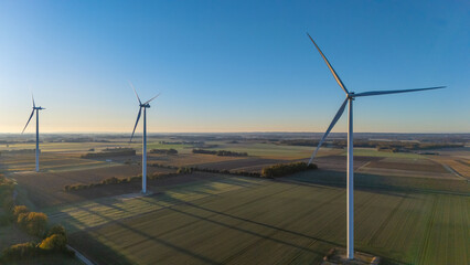 Wind Turbines Over Vast Agricultural Fields at Sunrise