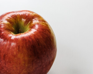 macro close-up of a red apple on a white background