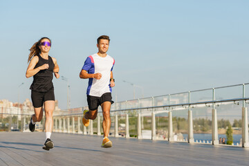 Runners enjoy a sunny day on the waterfront promenade while maintaining fitness and health