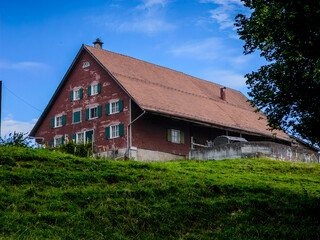 Intimate Perspective of Grass Fields Leading to a swiss Ranch in St. Gallen