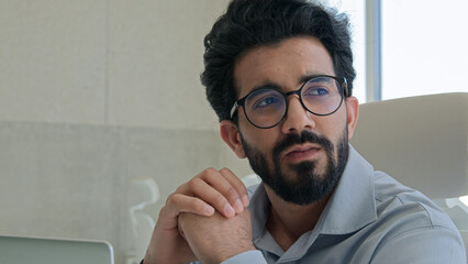Thoughtful pensive Arabian businessman marketing manager working computer in office Indian muslim...