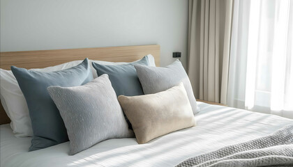 large view of bed in modern and scandinavian vibe bedroom set of pillows and bolster arranged aesthetically on bed professional photography soft tone no shadows and cont