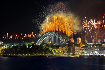 Obraz premium Sydney Harbour Bridge New Years Eve fireworks, colourful NYE fire works lighting the night skies with vivid multi colours NSW Australia. 