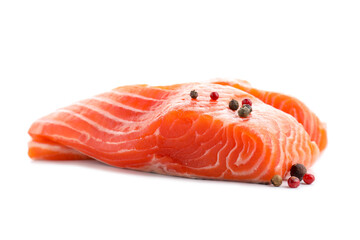 Pieces of fresh salmon and peppercorns isolated on white