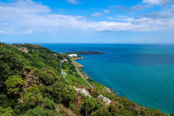 Scenic Coastal View with Green Hills and Ocean Horizon