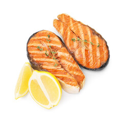 Tasty grilled salmon steaks with lemon and thyme isolated on white, above view