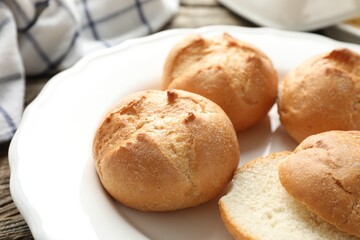 Plate with homemade tasty buns on table, closeup