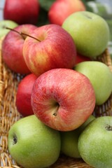Fresh ripe apples in wicker basket, closeup