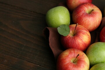 Fresh ripe apples on wooden table, closeup. Space for text