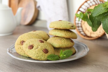 Delicious mint chocolate chip cookies on wooden table