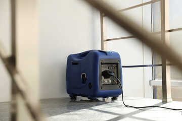 Modern portable power station on floor indoors