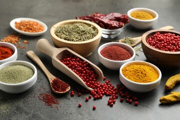 Different aromatic spices on grey table, closeup