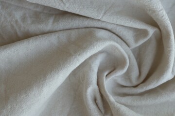 Grey textile napkin in white color as background. Folded decorative kitchen cotton towel