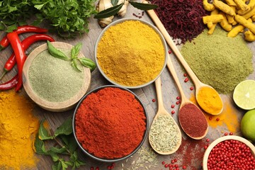 Different aromatic spices and herbs on wooden background, flat lay