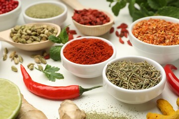 Different aromatic spices and herbs on white background, closeup