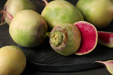 Whole and cut fresh turnips on table, closeup