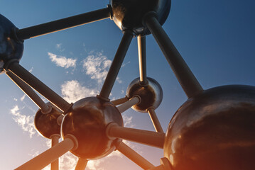 architectural object of large molecular structure on blue sky background, atom science and...