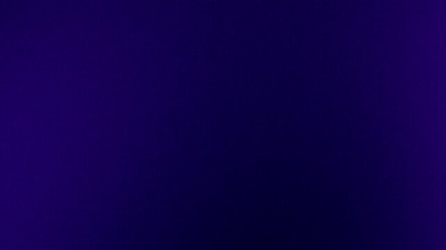 VHS-style grainy ultraviolet abstract background. Purple, blue, violet, black color blend effect. Dark transitions gradient flow in retro 80s 90s design for intro, cover, presentation. Grunge texture