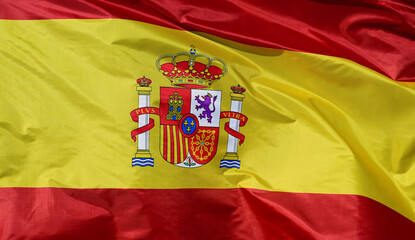 Fototapeta premium Close-up of the national flag of Spain, fluttering in the wind with folds, wave pattern
