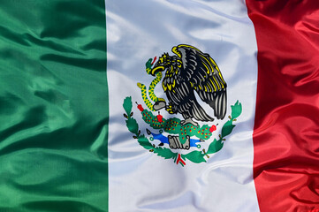 Close-up of the national flag of Mexico, fluttering in the wind with folds, wave pattern