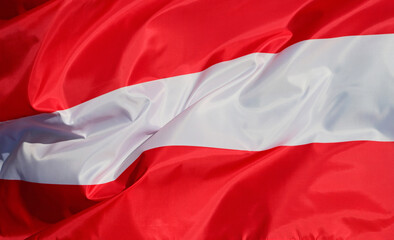 Close-up of the national flag of Austria, fluttering in the wind with folds, wave pattern