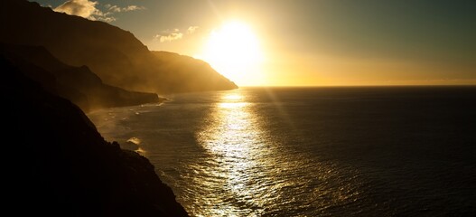 Streak of sun light across beautiful Hawaiian ocean and shores - sunset