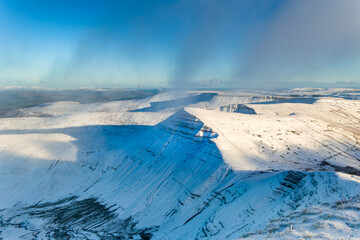Snow covered peak of Cribyn with low hanging cloud in the Brecon Beacons, Wales