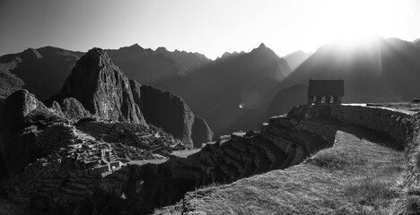 Sun shining on glorious hill and mountains of Machu Picchu - black and white wide image