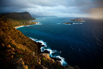 Epic high shot over Hawaiian mountain to shore and ocean below