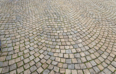 Full frame abstract texture background of a European cobblestone courtyard surface with gray and beige stones