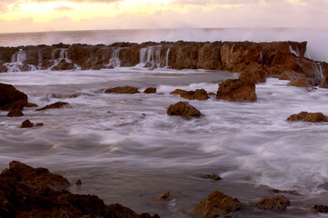 Fototapeta premium Beautiful island shore rocky patch at dusk - slow shutter speed