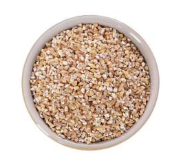 Dry wheat groats in bowl isolated on white, top view