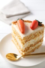 Piece of delicious carrot cake on white wooden table, closeup