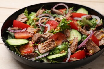 Delicious fresh tuna salad on table, closeup