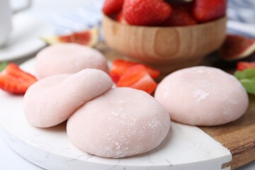 Delicious mochi and strawberries on table, closeup
