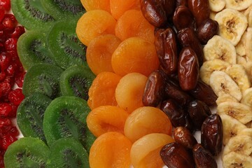 Mix of different dried fruits on table, top view