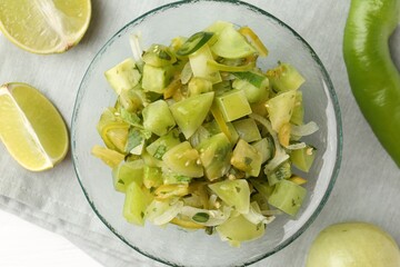 Delicious salsa (Pico de gallo) in bowl and products on white table, top view