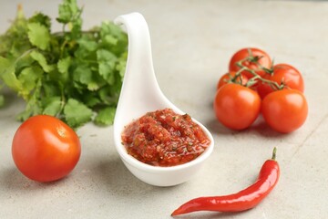 Delicious salsa sauce and ingredients on light textured table, closeup