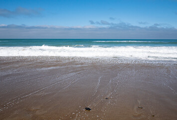 Peaceful sandy beach and calm ocean New Zealand beautiful nature