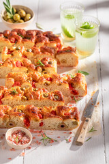 Tasty and homemade focaccia freshly baked and served with lemonade.